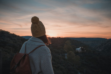 Young girl traveling by nature with backpack and dog