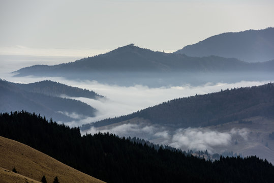 A view from mountains to the valley covered with foggy landscape. Foggy Landscape in mountains.