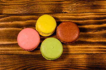 French macaroons on wooden table. Top view
