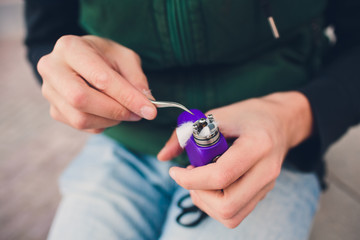 Maintenance of electronic mech mod vaping device.Modern vaporizer e-cig gadget to vape glycerin...