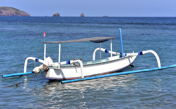 Fototapeta Fishing boat floating on the beach of Candi Dasa, Candi Dasa, Bali, Indonesia