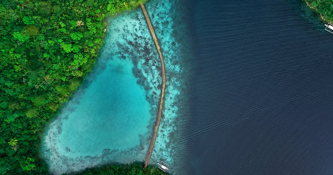 Aerial view of Sugba lagoon. Beautiful landscape with blue sea lagoon and bridge, National Park, Siargao Island, Philippines