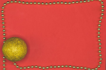 Red copy space with golden border chord and christmas glittered ball.