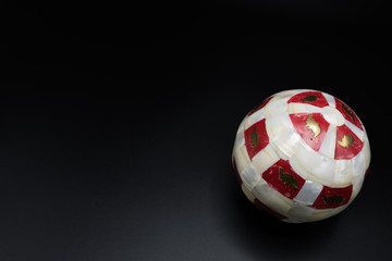 White and red christmas bauble. Left copy space.