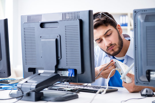 IT technician looking at IT equipment