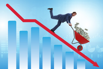 Businessman pushing money wheelbarrow down the chart