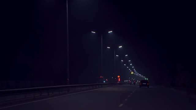driving on the night highway. Cars are driving on the way to home in the evening