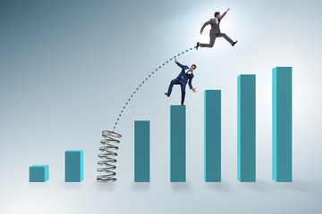 Businessman outperforming his competition jumping over