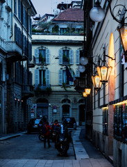 small street in Milan at night in the light of the lanterns. Italy