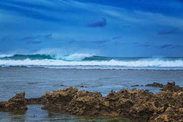 Beautiful sea landscape on the background of dramatic cloudy sky and corals. Siargao island, Philippines