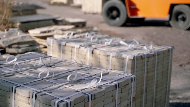 special professional equipment is transporting pallets with bricks in the production area. Warehouse equipment