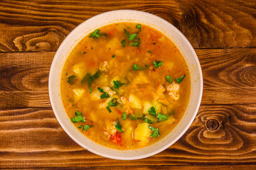 Georgian traditional food soup kharcho on wooden table. Top view