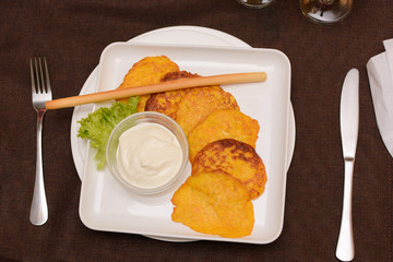 Draniki - potato fritters. potato pancakes with pumpkin. The naitonal dish of Belarus, Ukraine and Russia