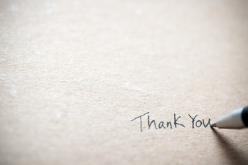 Hand writing thank you on piece of old grunge paper - obrazy, fototapety, plakaty