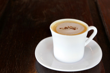 hot cappuccino coffee on wooden table