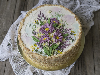 Napoleon cake with vanilla cream, decorated with buttercream flowers. Vintage style. Wooden...