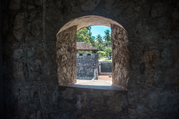 Looking out of the stone window of Castillo de San Felipe, a castle in Rio Dulce, east Guatemala 