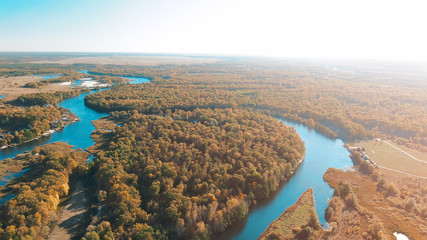 Fototapeta na wymiar Cinematic aerial view, flight over a beautiful meandering river, panoramic view from a great height