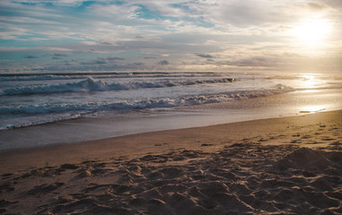 Waves lap at the beach during sunset in Santa Teresa, Costa Rica