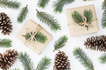 Top view of Christmas composition, gift box, pine cones, fir branches on white background