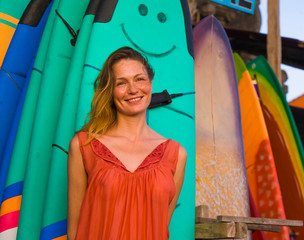  young beautiful and happy blond woman smiling relaxed and cheerful posing with colorful surf...