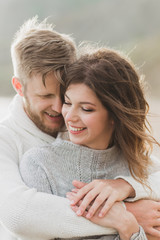 Close-up portrait of man and woman together, happy, looking at each other. Smiling, kissing and laughing