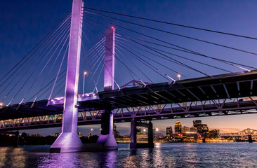 Louisville, Kentucky, USA downtown skyline from under the Abraham Lincoln bridge on the Ohio River at dusk.