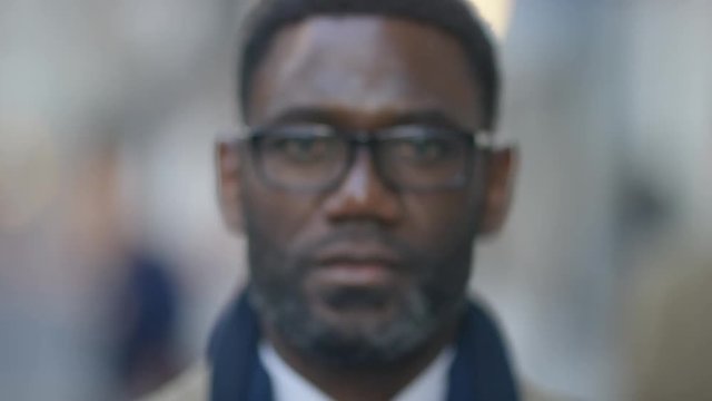 Portrait of confident business man looking to camera, in slow motion 