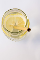 Lemon water and bamboo drinking straw.
