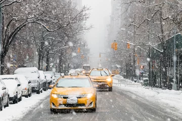 Wall murals New York TAXI Taxis drive down a snow covered 5th Avenue during a winter nor'easter storm in New York City