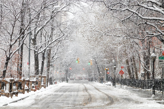Snow covered street along Washington Square Park after a nor'easter snow storm in New York City - Powered by Adobe