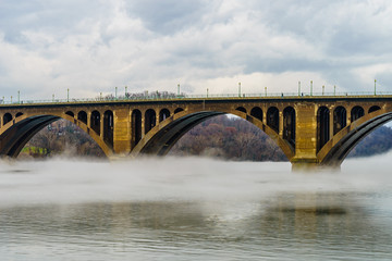 Fototapeta na wymiar Francis Scott Key Bridge across Potomac River, winter fog on the water.
