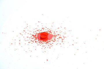 Red paint splash onto white background in crown