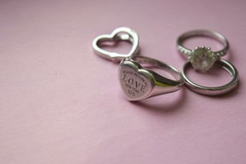 wedding rings on pink background