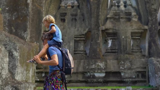 Slowmotion shot of a father and son having fun visiting the Gunung Kawi Sebatu Temple on the Bali island