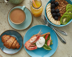 Overhead view of freshly delicious healthy breakfast served on wooden table. Healthy food
