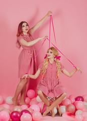holidays and dolls. Crazy girl on pink. Halloween. vintage fashion women puppet. Creative idea. Funny advertising. retro girls in party balloons. Going crazy together. Going crazy