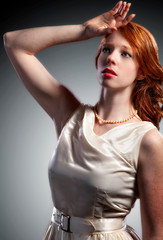 Naklejka premium beautiful young woman with wavy crimson red long hair has an amazing glow
