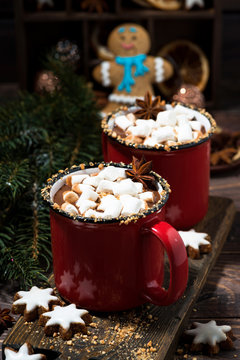 cozy winter drink hot chocolate in red mugs on wooden table, vertical
