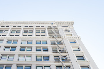 Fototapeta premium White Building Facade with Windows and Blue Sky
