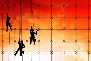 Silhouette illustration on group of builders are working on construction area site in sunset view.