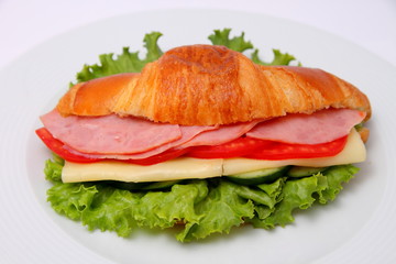 sandwich with ham lettuce leaves cheese and tomatoes with cucumber