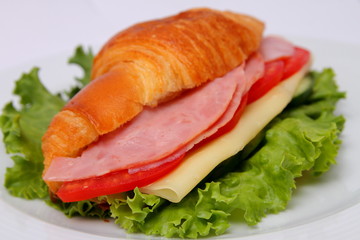 sandwich with ham lettuce leaves cheese and tomatoes with cucumber