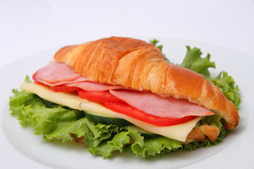 sandwich with ham lettuce leaves cheese and tomatoes with cucumber