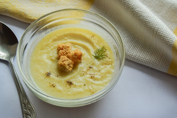 Soup puree with croutons and dill. Sprinkled with black pepper.