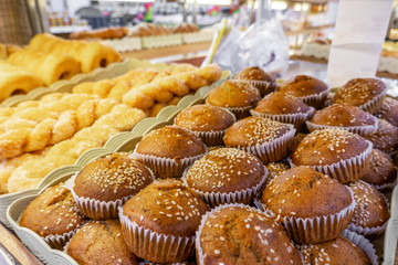 The fresh bakery set such as donut , bread  etc in the plastic tray for sell in the shop.