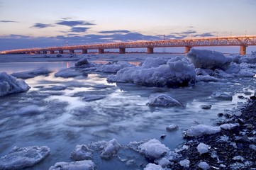 Spring ice drift on the Amur river. Area of the Amur bridge. Trans Siberian railway. Khabarovsk,...