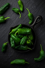 Spanish green peppers on frying pan