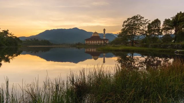 Beautiful sunrise with reflection of sunrise and the Darul Quran Mosque
