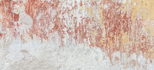 Old cracked weathered shabby plastered peeled wall banner background